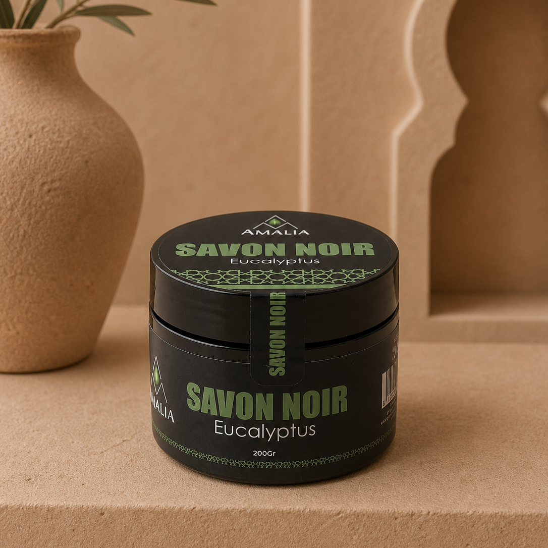 Jar of Savon Noir Eucalyptus soap with 'Amalia' branding on a beige background.